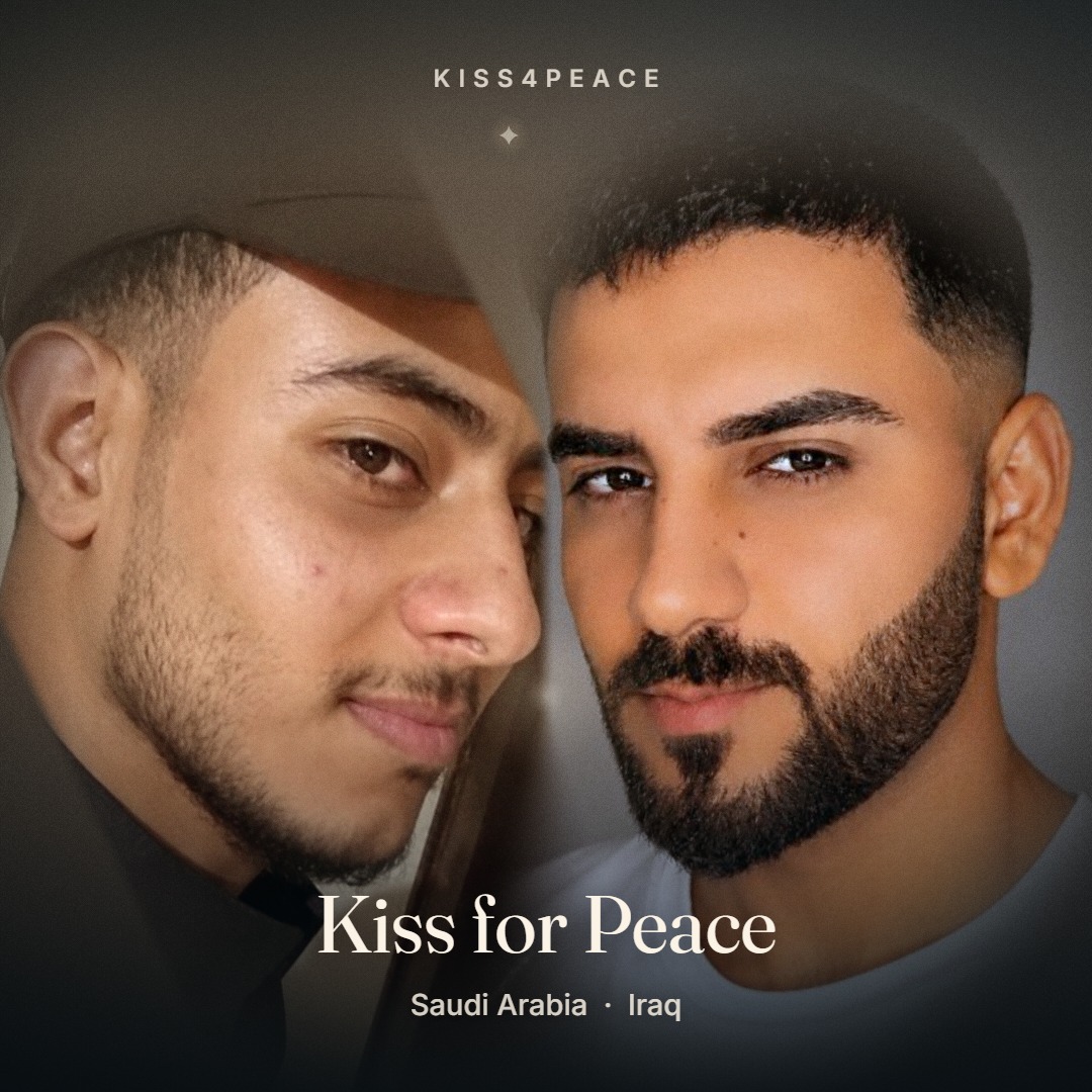 A kiss for peace between two strangers from Saudi Arabia and Iraq
